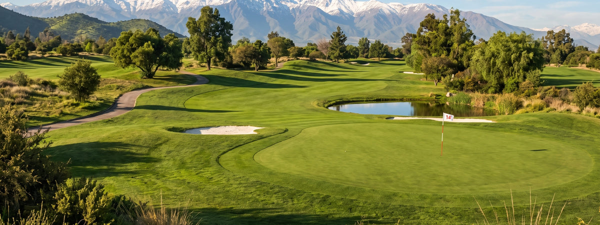 Cancha de golf con el green, la laguna y la bandera del hoyo, y la cordillera nevada al fondo - E-Mobility Chile