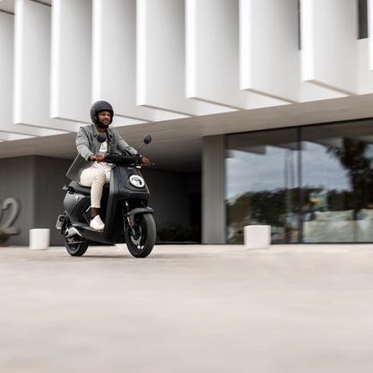 Persona conduciendo una Moto Eléctrica NIU MQi GT por la ciudad - E-Mobility Chile, Las Condes